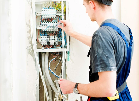 Technician assessing an electrical system, showcasing the expertise and benefits of choosing professional electrical services in Coral Springs, FL.