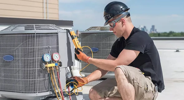 Technician servicing HVAC equipment in a commercial setting in Miami, FL, emphasizing efficient heating and cooling solutions for businesses.