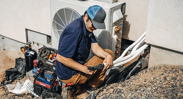 Technician working on a custom HVAC installation in Coral Springs, FL, illustrating tailored solutions for heating and cooling systems that enhance energy efficiency.