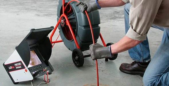 Technician performing drain cleaning and unclogging services in Miami, FL, demonstrating efficient methods for restoring proper plumbing function and maintaining system efficiency.