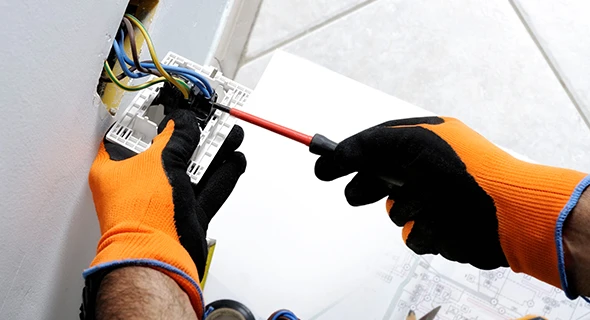 Technician performing electrical repairs and installations in Delray Beach, FL, demonstrating comprehensive electrical services for residential needs.