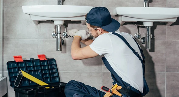 Plumber efficiently resolving a plumbing leak in Delray Beach, FL, showcasing emergency plumbing repair services for residential and commercial properties.
