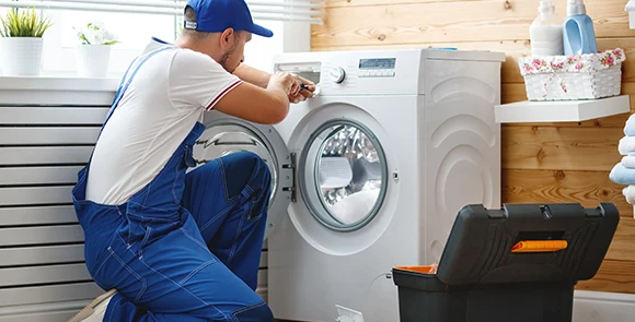 Professional technician reviewing a washing machine during an appliance repair service in Miami, FL, highlighting reliability and local expertise in appliance maintenance.