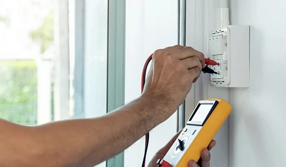 Technician connecting a power outlet while providing local electrical services in Coral Springs, FL, emphasizing professional and reliable electrical work for homeowners.