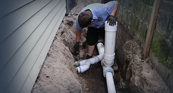 Plumber inspecting and repairing a sewer line in Coral Springs, FL, utilizing specialized tools for effective plumbing solutions to blockages and damaged pipes.